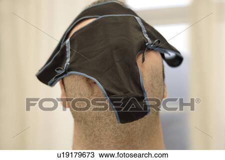 Stock Image - Young man has his underpants on his face, close up. Fotosearch