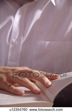 Young man reading a book, close up of hand on the page View Large Photo Image Stock Image - Young man reading a book, close up of hand on the page. Fotosearch