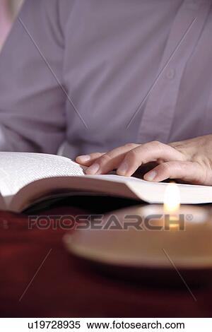 Stock Photography - Young man reading a book. Fotosearch
