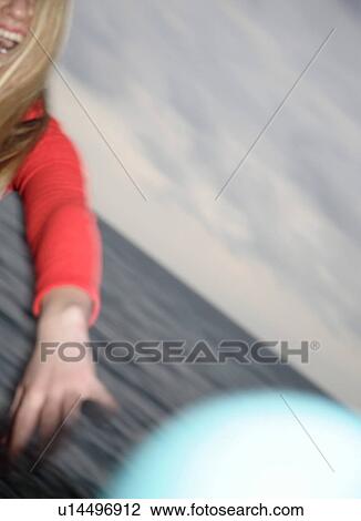 Young woman playing with a ball at the beach View Large Photo Image Stock Image - Young woman playing with a ball at the beach. Fotosearch