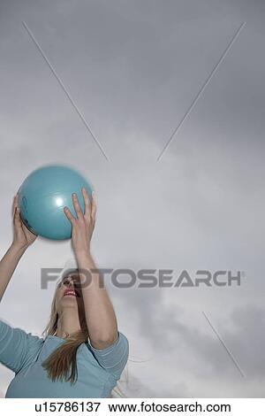 Young woman playing with a ball at the beach View Large Photo Image Stock Photo - Young woman playing with a ball at the beach. Fotosearch