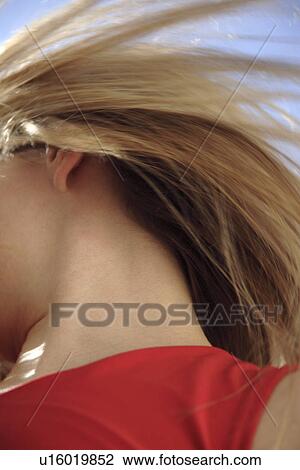 Young woman throwing her long blond hair in front of blue sky, low angle view View Large Photo Image Stock Image - Young woman throwing her long blond hair in front of blue sky, low angle view. Fotosearch