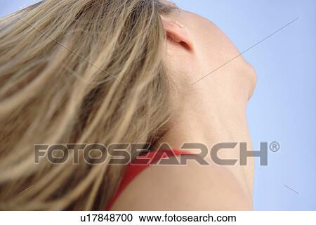 Young woman throwing her long blond hair in front of blue sky, low angle view View Large Photo Image Stock Image - Young woman throwing her long blond hair in front of blue sky, low angle view. Fotosearch