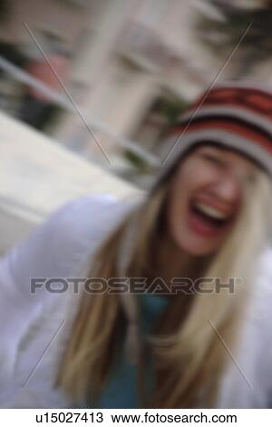Young woman wearing knitted cap, running and laughing at the beach, close up View Large Photo Image Stock Image - Young woman wearing knitted cap, running and laughing at the beach, close up. Fotosearch