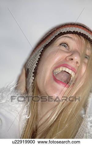 Young woman wearing knitted cap, running and laughing at the beach, close up View Large Photo Image Stock Image - Young woman wearing knitted cap, running and laughing at the beach, close up. Fotosearch