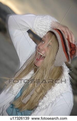Young woman wearing knitted cap, running and laughing at the beach, close up View Large Photo Image Stock Photo - Young woman wearing knitted cap, running and laughing at the beach, close up. Fotosearch