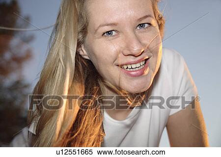 Young woman with long blond hair after jogging at the beach, portrait View Large Photo Image Stock Photography - Young woman with long blond hair after jogging at the beach, portrait. Fotosearch