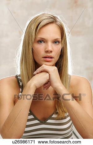 Stock Image - Young woman with long blond hair, portrait. Fotosearch