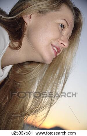 Young woman's face profile at the beach at dusk View Large Photo Image Stock Image - Young woman's face profile at the beach at dusk. Fotosearch