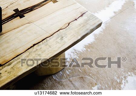 Stock Image - Country Living Room with Log Table and Cow Hide. Fotosearch