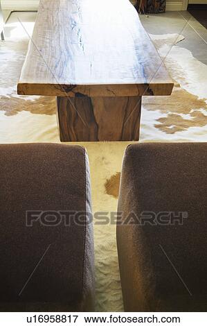 Stock Photo - Country Living Room with Log Table and Cow Hide. Fotosearch