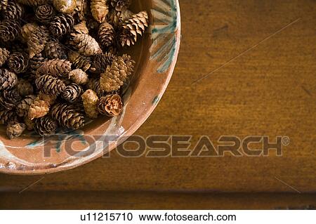 Detail of bowl filled with miniature pinecones. View Large Photo Image Stock Image - Detail of bowl filled with miniature pinecones. . Fotosearch