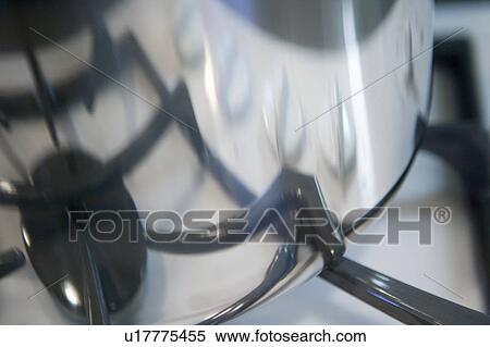 Stock Photography - Detail of chrome boiling pot withe reflection of stove range. Fotosearch