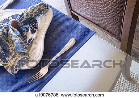 Stock Photograph - Detail of place setting with plate, fork and napkin. Fotosearch