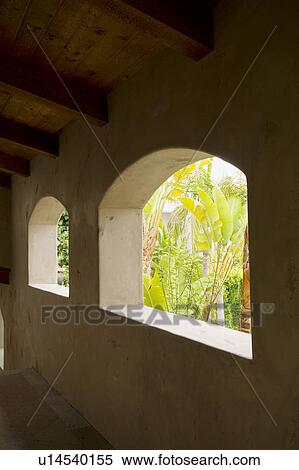 Stock Photography - Detail of receding arches with vegetation in view.. Fotosearch