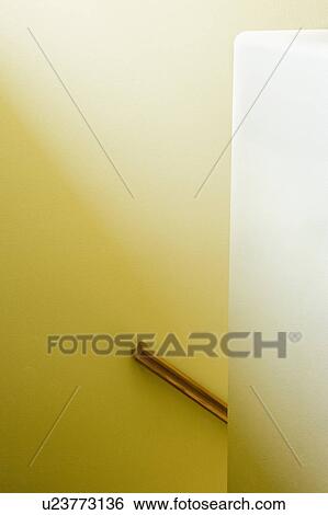 Stock Photograph - Detail of Staircase Railing on Yellow Wall. Fotosearch