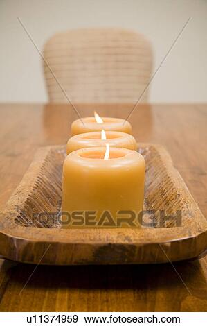 Detail of three lit candles on wooden holder View Large Photo Image Stock Photo - Detail of three lit candles on wooden holder. Fotosearch
