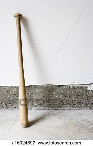 Stock Photo - Detail of wooden baseball bat against white and concrete wall.. Fotosearch