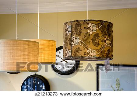 Stock Image - In Store Display of Clocks and Lampshades. Fotosearch