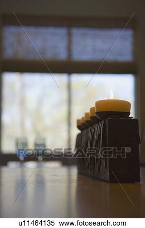 Lined up candles in holders on a dining room table View Large Photo Image Stock Photography - Lined up candles in holders on a dining room table. Fotosearch