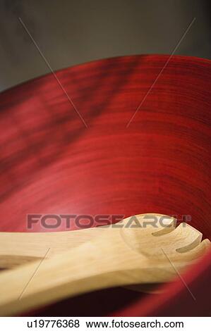 Stock Photo - Red Wood Bowl with Wood Serving Utensils. Fotosearch