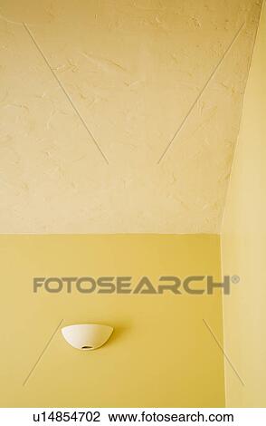 Stock Image - Sconce on Wall in Yellow Room. Fotosearch