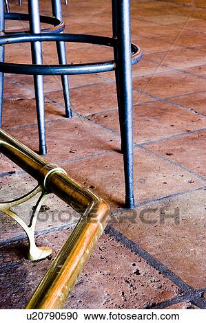 Stock Image - Terra Cotta Floor and Bar Stool Legs. Fotosearch