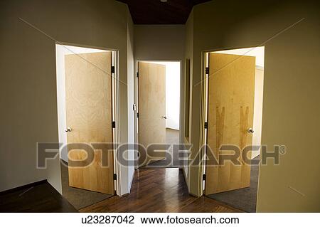 Stock Image - Three Open Doors in Modern Hallway. Fotosearch