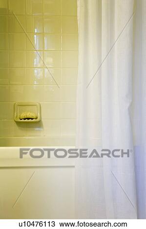 Stock Image - Tile Shower and White Shower Curtain in Traditional Bathroom. Fotosearch