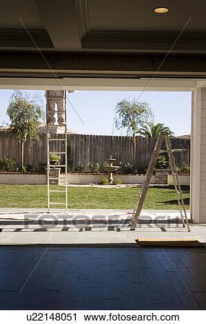 View from Inside of Man on Ladder in Backyard View Large Photo Image Stock Image - View from Inside of Man on Ladder in Backyard. Fotosearch