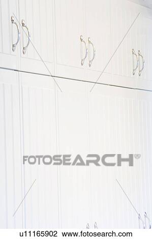 Stock Image - White Cabinets and Handles. Fotosearch