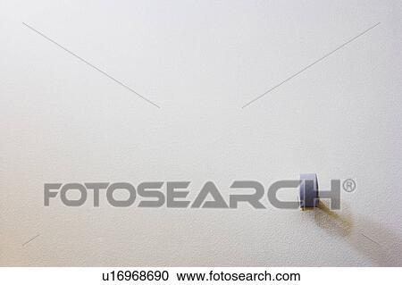 Stock Image - White Surround Sound Speaker Mounted on White Wall. Fotosearch