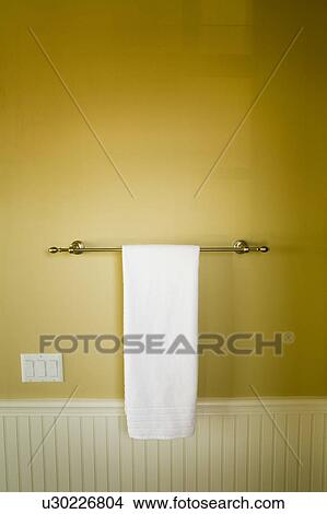 Picture - White Towel, Towel Bar, and Yellow Bathroom Wall. Fotosearch