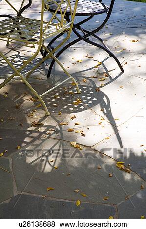 Stock Photo - Wrought Iron Outdoor Dining Table and Chairs. Fotosearch