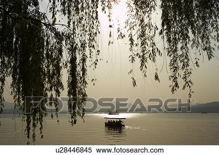 Boat on West Lake in Hangzhou, People's Republic of China View Large Photo Image Stock Photography - Boat on West Lake in Hangzhou, People's Republic of China. Fotosearch