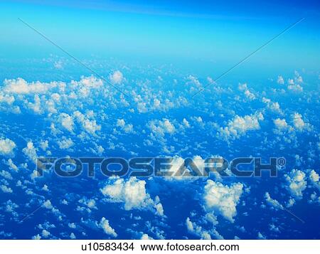 Clouds from airplane window, elevated view View Large Photo Image Picture - Clouds from airplane window, elevated view. Fotosearch