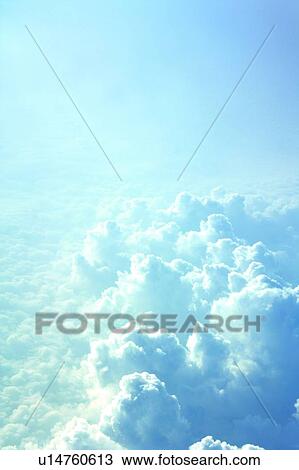 Stock Image - Clouds from airplane window, elevated view. Fotosearch