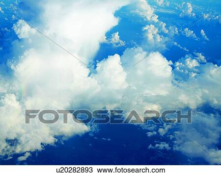 Clouds from airplane window, elevated view View Large Photo Image Stock Image - Clouds from airplane window, elevated view. Fotosearch