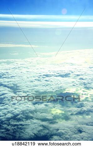 Stock Photo - Clouds from airplane window, elevated view. Fotosearch