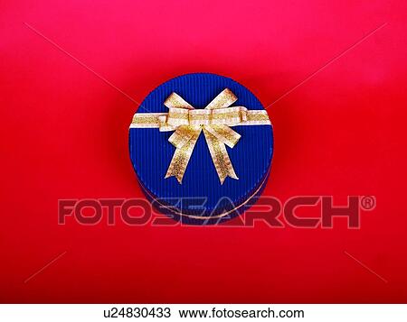 Round shaped box with golden bow, elevated view View Large Photo Image Stock Image - Round shaped box with golden bow, elevated view. Fotosearch