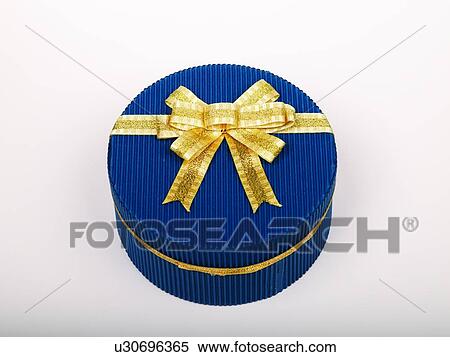 Stock Photography - Round shaped box with golden bow, elevated view. Fotosearch