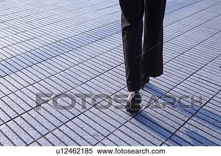 Young Businesswoman walking, Low Section, Rear View View Large Photo Image Stock Photography - Young Businesswoman walking, Low Section, Rear View. Fotosearch