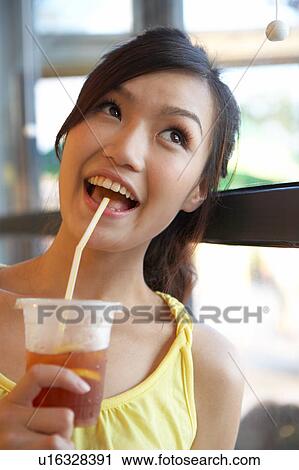 Young Lady Holding Cold Drink View Large Photo Image Stock Image - Young Lady Holding Cold Drink. Fotosearch