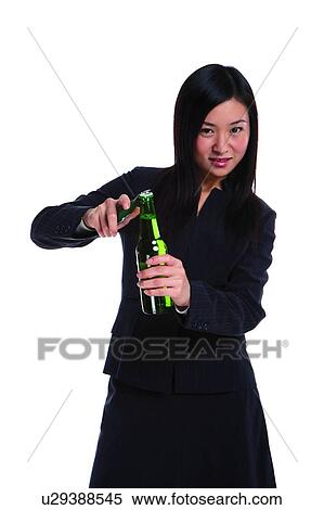 Young woman in business suit, opening bottle View Large Photo Image Stock Photography - Young woman in business suit, opening bottle. Fotosearch