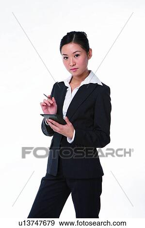 Young woman in business suit, standing, inputting data View Large Photo Image Stock Photo - Young woman in business suit, standing, inputting data. Fotosearch