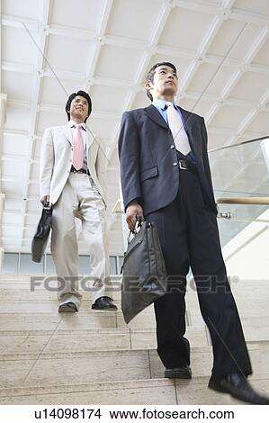 Businessmen walking down stairs View Large Photo Image Picture - Businessmen walking down stairs. Fotosearch