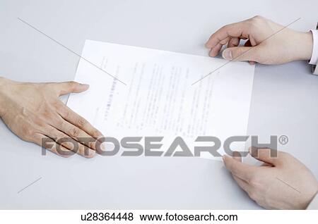 Exchanging a business document View Large Photo Image Stock Photo - Exchanging a business document. Fotosearch