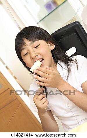 Girl eating an apple View Large Photo Image Picture - Girl eating an apple. Fotosearch