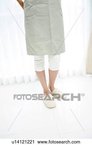 Stock Image - Lower half of standing woman. Fotosearch