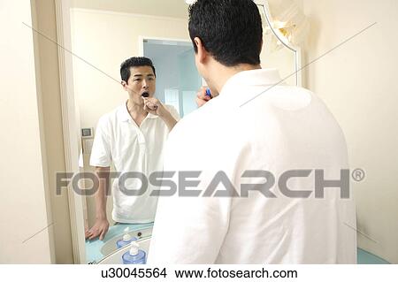 Man brushing his teeth View Large Photo Image Picture - Man brushing his teeth. Fotosearch